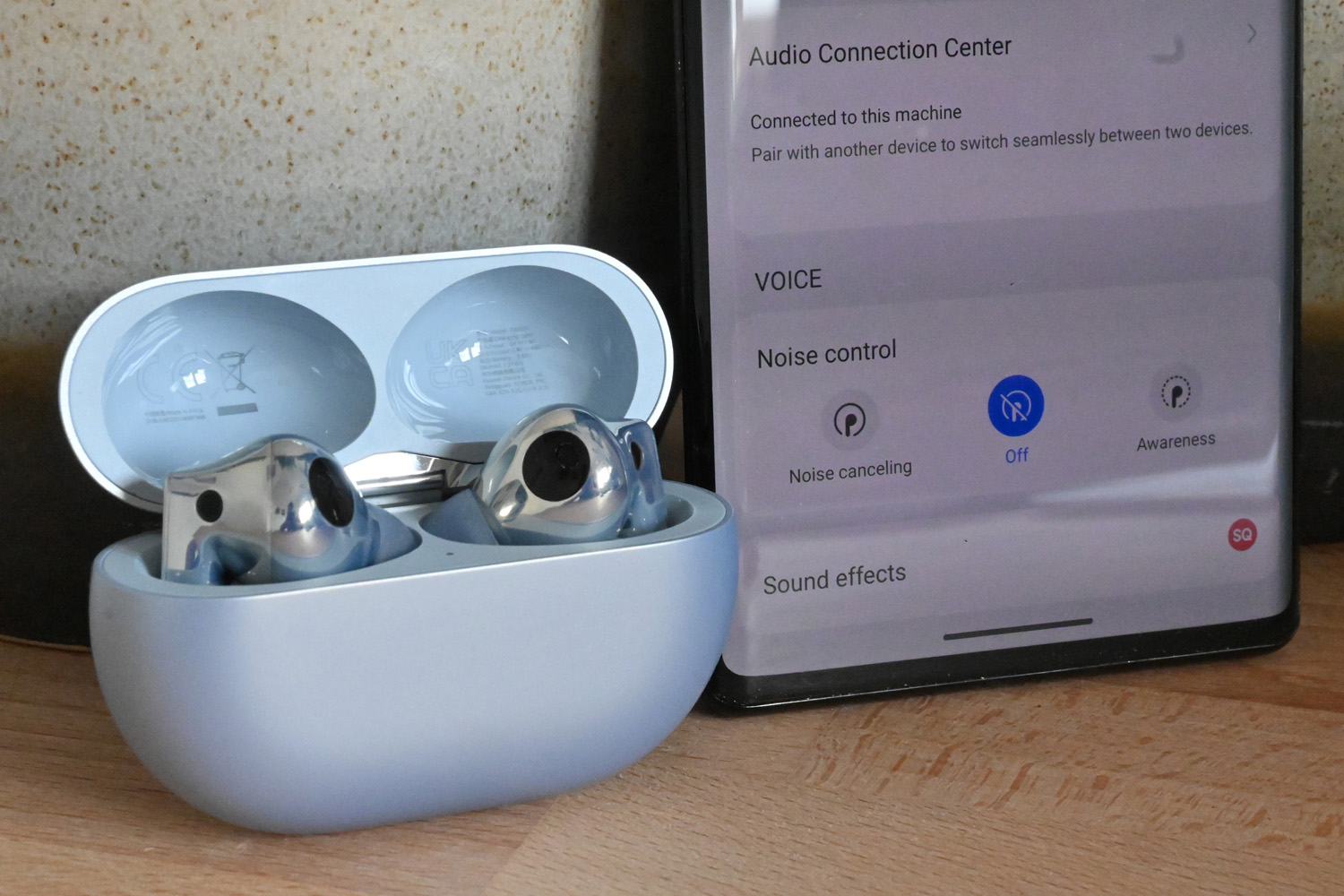 Huawei FreeBuds Pro 2 hands-on review Stuff - close-up near phone
