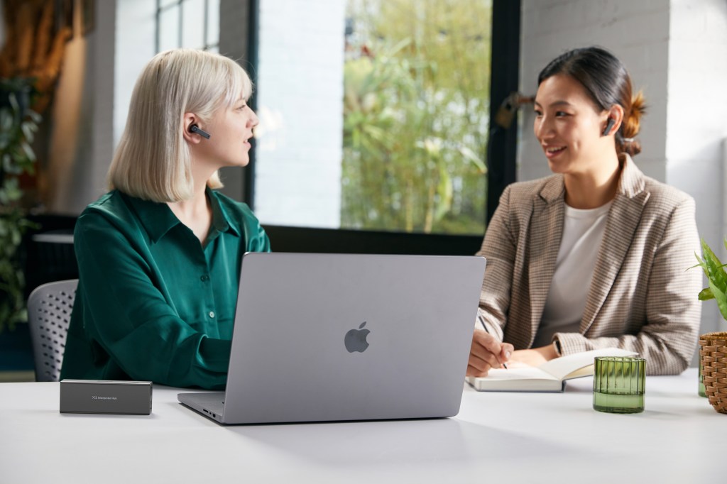 Timekettle X1 Interpreter Hub in use by two women