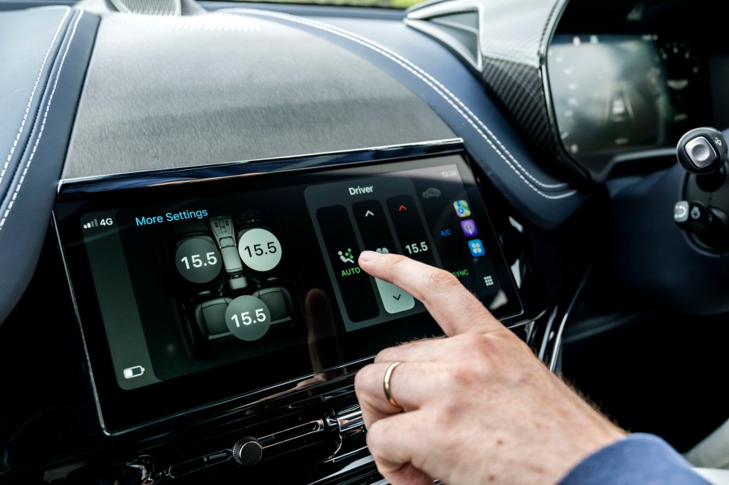 Finger pointing to Apple CarPlay Ultra display